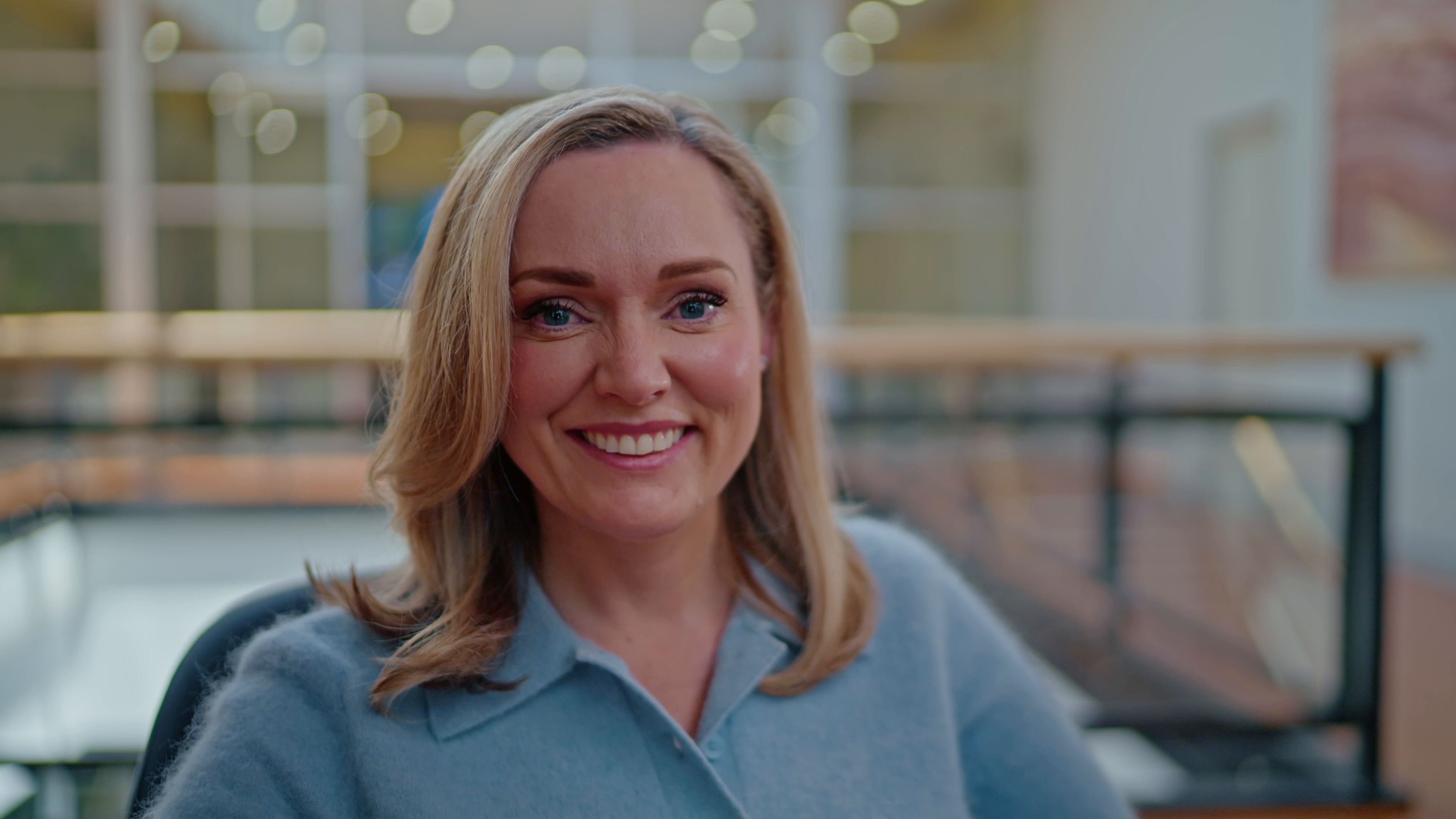 Smiling interview portrait in a warm, light-filled interior