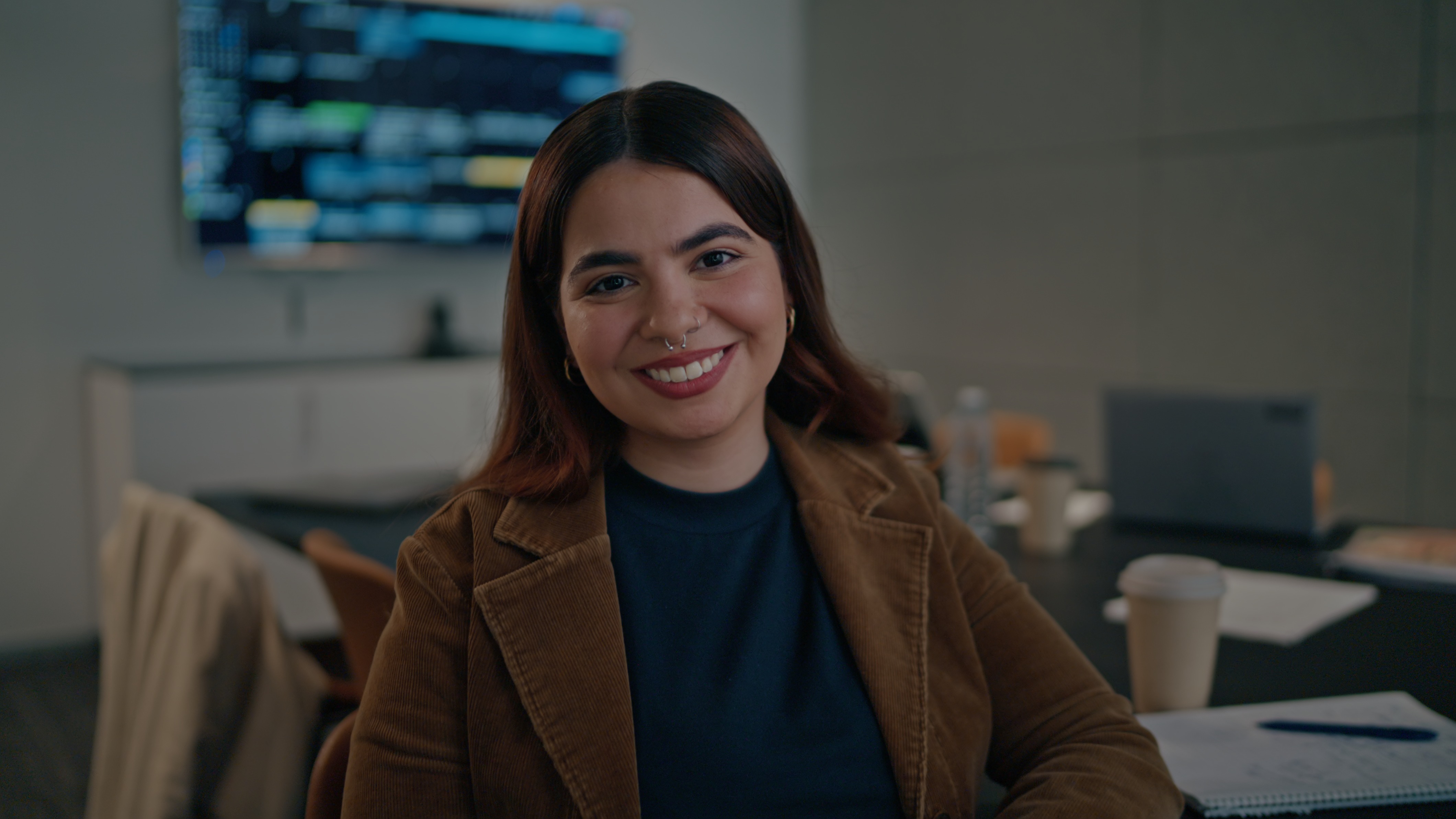 Smiling portrait to camera in a modern office
